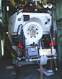 The submarine Alvin sits in its hanger onboard R/V Atlantis. The boxing gloves on Alvin&acirc;s manipulator protect people who are loading the basket from bumping their heads.