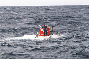 The submarine Alvin sits in its hanger onboard R/V Atlantis. The boxing gloves on Alvin&acirc;s manipulator protect people who are loading the basket from bumping their heads.