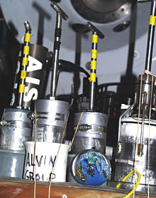 The “planet” sits on the biobox in Alvin’s basket, waiting to be secured for the trip down to the seafloor. In back sit the sediment corers and the Analytical Instrument Systems Inc. (AIS) Electrochemical Analyzer. 