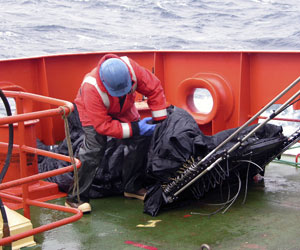 Once the net is on the deck, Josh Eaton locates the sample containers.