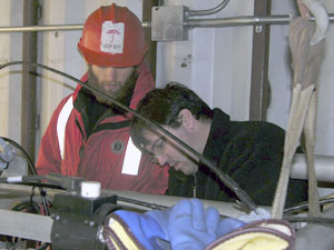 WHOI engineering assistant Josh Eaton (right) and Byron Pedler inspect LAPIS (Large Area Plankton Imaging System) before its first tow. (Photo by Larry Madin, WHOI)