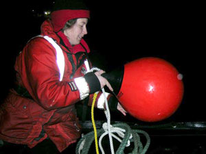 Wally pulls in the down line and the dive float, preparing to head back to the ship after the dive.