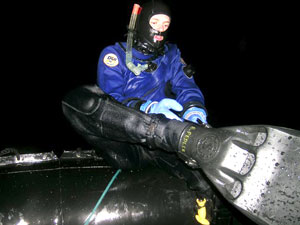 What goes on must come off, and Byron Pedler removes his fins after the dive, because there is not enough room for divers to wear them in the boat.