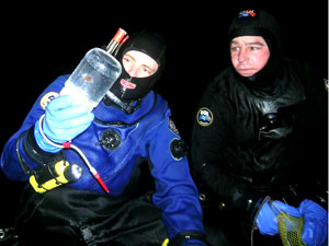 The reason for the dive: Byron Pedler holds up a salp in one of the collecting jars, as Erich Horgan watches.