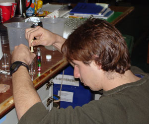 Brennan prepares a &ldquo;sucrose density gradient&rdquo; in a test tube. He makes water with sugar dissolved in it. First, he makes water with a lot of sugar dissolved in it (a high density of sugar) and uses one food coloring to identify it. 
