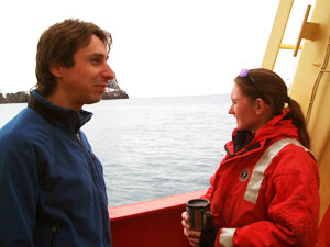 Brennan Phillips, graduate student at the University of Connecticut, and Kerri Scolardi, a marine biologist at Mote Marine Laboratory, watch as the L. M. Gould moves through Neptune&rsquo;s Bellows into Deception Island&rsquo;s lagoon. (Photo by Kelly Rakow, Woods Hole Oceanographic Institution)