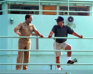 Captain George Silva, the Master of R/V Atlantis, (on right) and Captain Tim McGee of the Naval Oceanographic Office (NAVOCEANO) discuss the upcoming cruise plans as the ship steams away from Manzanillo. 