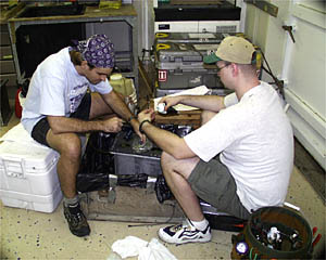 Students Greg Kurras (left) and Del Bohnenstiehl rebuilding the Towed Camera Sled batteries in the Wet Lab. 
