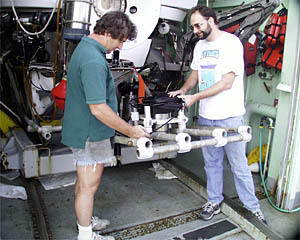 Expedition Leader Pat Hickey and Andy Billings of the Alvin Group install the Doppler Sonar on Alvin’s basket. 