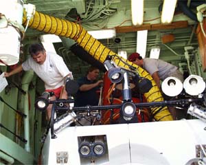 Dan Fornari climbs off Alvin’s deck after finishing his dive briefing. 