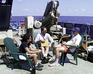 Danielle Fino, Dive & Discover’s web designer (left), Paul Oberlander, an artist in WHOI’s Graphic Department (middle), and Dan Fornari plan the day’s work. 