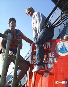 Jim is happy about the dive as he steps out of Alvin after the dive, while Bruce Strickrott, the Launch Coordinator looks on. 