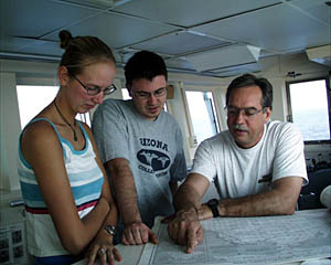 Dan Stuermer teaches Julie Barber and Sam Dean about reading nautical charts on the Bridge of R/V Atlantis. .