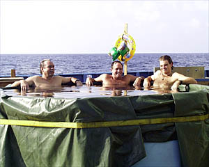 Dan Stuermer (left) Tim McGee (center) and Gregg Kurras cool off in the pool.