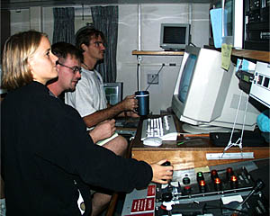  Jenny (foreground), Del (middle) and Greg stand watch at the echosounder monitor to keep track of the Towed Camera's height above the seafloor.