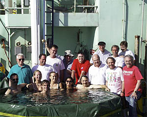 Members of the scientific party on Cruise #2 pose near (and in!) the pool on the fantail of R/V Atlantis. 
