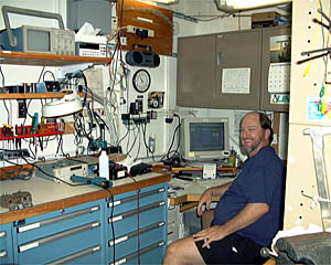 Dave Sims, the SSSG (Shipboard Science Services Group) technician, sits in his office. Every morning Dave makes sure the updated website makes it to your computer onshore. He also takes care of the email system on board Atlantis and getting the scientists the data from Alvin. 