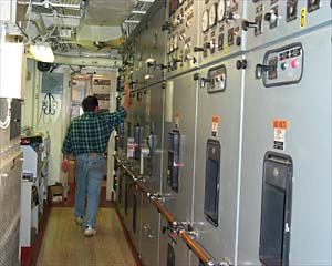  Control panels for the six main engines. Chris Morgan makes an adjustment to the generator control panel. 