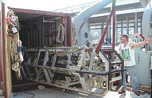 Ron Comer, resident technician, directs the unloading of the Argo II system.