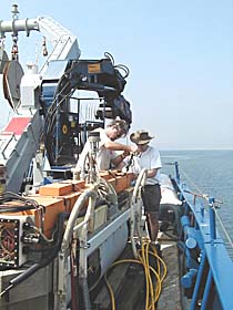 PJ Bernard (left) and Craig Elder prepare the DSL-120 sonar for its first deployment. The sonar “fish” is towed 100 meters above the seafloor. It produces sidescan sonar maps that give us very precise images of the seafloor’s structure and topography along swaths that are about 1,000 meters wide. 