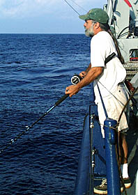 Able-Bodied Seaman (ABS) Dave Grimes makes a few casts out to sea just after the sun breaks over the horizon. Play before work? No, in fact, Dave just got off his 0400-0800 watch. His first break of the day is well-earned. 