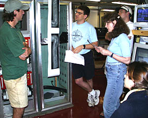 Rachel Haymon (right, standing) and Dan Scheirer (center) explain how to interpret DSL-120 sidescan sonar data to students Tim Haskell and Clare Williams in the main lab.