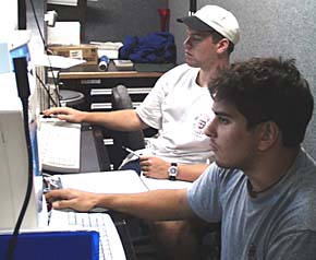 John Burgess (foreground) and Ben Wigham at the data logging and sonar control stations in the Main Van. They are part of Mike Perfit’s scientific watch team along with Erin Todd. 