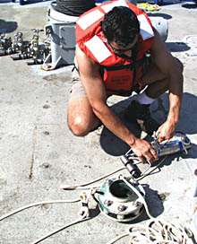 Rob Palomares, Scripps’ CTD technician, unbolts a MAPR (Miniature Autonomous Plume Recorder) from a line connected to our DSL-120 sonar fish. As the “fish” surveyed the seafloor over the last three days, the MAPR collected data about seawater properties (temperature, conductivity, and how clear the water was) about 75 meters above the ocean bottom. We are now downloading data from the MAPR and will analyze it during the next few days. 
