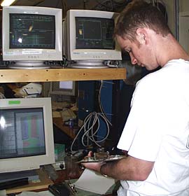 Tim Head stands the multibeam sonar watch on R/V Melville. He has to keep good notes so that when we process the data it is as accurate as possible. 