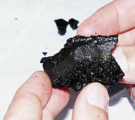 One of the small samples of volcanic glass recovered from about 3060 meters water depth on the East Pacific Rise axis near 3&deg; 23.30’N and 102&deg; 14.36’W. Note the very shiny surface of the lava. This forms when hot, molten rock is quenched (very rapidly chilled) when it comes in contact with the near-freezing seawater.