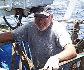 Bill Kamholtz, Melville’s Bosun, chips rust off the power control panel for the aft crane on R/V Melville. Cranes are a critical piece of shipboard equipment needed to lift and move heavy pieces of equipment around the deck, and to load and unload the ship when it is in port. Notice that Bill is wearing safety glasses to protect his eyes as chips of rust can fly everywhere. 