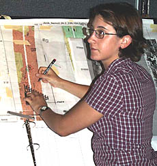 Clare Williams plots Argo II’s position on a seafloor map in the Control Van. She is using enlarged maps of the DSL-120 sonar imagery and bathymetry to make sure that we are going over the areas where we expect to find the recently erupted lava flow.