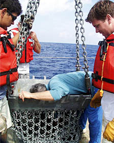 The dredge comes on board R/V Melville. We have dragged it over the lava flows on the East Pacific Rise crest eight times in the past few days to collect rocks. This dredge was actually “hung-up” or stuck on the seafloor for about an hour. We suspect that it got wedged into one of the cracks or fissures that we saw in the Argo II video. Thankfully, we were able to get it unstuck! 
