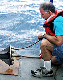 Mike Perfit checks to see whether we any glass samples were collected in the pale yellow wax in the cups on the end of the corer. So far we have successfully collected glass all but one of the times we have sent the rock corer to the seafloor. 