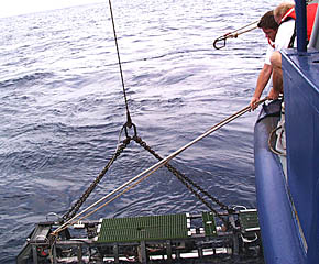 Getting Argo II on board R/V Melville is no easy task! Ben Wigham (left) and Ron Comer (hanging on to Ben!) have just attached a restraining line to Argo II to keep it from swinging as it is brought on board.