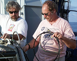 PJ Bernard (left) and Bob “Yogi” Elder prepare Argo II for its first lowering at this study site. Yogi is holding the end of the fiber optic cable that attaches to the Argo II vehicle. All of the power and data telemetry goes through these thin wires. It’s an amazing feat of technology! 