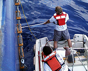 Washing your car is easy compared to washing the hull of a ship! Dave Murline and Cletus Finnell give R/V Melville’s hull a scrub-down today.