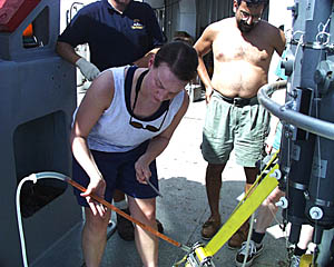 Julia Getsiv drawing a water sample from a Niskin bottle that will be sent for helium analysis to be done by Dr. John Lupton, one of our shore-based collaborators. The sample is stored in the copper tube; Julia taps the tube with the wrench to get the air bubbles out so that they do not contaminate the sample.