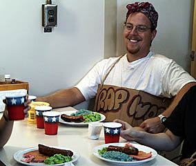 A special “Dr. Suess” breakfast for the Pollywogs this morning -- green eggs and ham, blue oatmeal, and large sausages. Mmmmm! How appetizing! The sign around Erin Todd’s neck is the “Pollywog name” assigned to him by the Shellbacks. Erin’s name is “Rap” because rap is his favorite kind of music. Each Pollywog receives his or her own special name that reflects humorous elements of the personalities or habits of each person. 