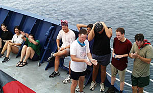 Newly inducted Shellbacks watch the rest of the Pollywogs go through the Ceremony. From left to right: Kate Gans, Clare Williams, Julia Getsiv, Erin Todd, Jon Burgess, Ben Wigham, Peter Lean, Tim Haskell, and Tim Head (in front). 