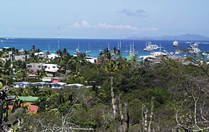 The view from one of the hills above Puerto Ayora, Santa Cruz Island, Galapagos Islands. R/V Melville is the large ship in the far distance in the upper right side of the photo. Many cruise ships anchor in Puerto Ayora and take tourists to the different islands. 