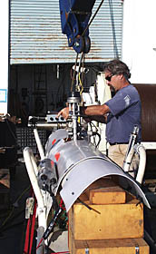 PJ Bernard prepares the DSL-120 sonar fish for deployment. 