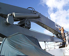 Dave Grimes puts the finishing touches on the superb paint job that the deck crew gave the aft crane over the past few weeks. It looks brand new! 