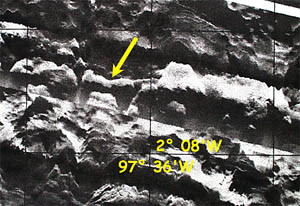 A portion of the DSL-120 backscatter imagery for the same area shown in the previous photos. The yellow arrow points to the reflective ridge that we suspect may have young lava on it.