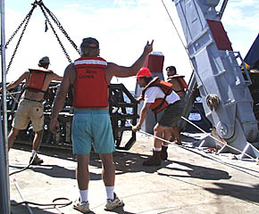 Ron Comer, the Scripps Resident Technician, directs the recovery operation for Argo II this afternoon. Assisting are: Tim Haskell (left), Craig Elder (center), and Rob Palomares (right). 