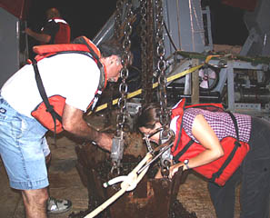 We got rocks! Mike Perfit (left) and Clare Williams unload the chain bag after the first dredge this evening.