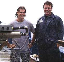 Some kids just don’t know enough to get out of the rain! Greg Kurras (left) and Ben Wigham (right) enjoy an outdoor shower in the warm tropical downpour this afternoon. 