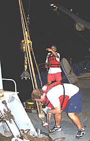 Dan Fornari (giving signals) and Erin Todd deploy “Mighty Mo” to take more samples of volcanic glass from the seafloor at depths of 3300 to 3600 meters.