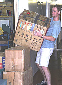 Tim Head moves boxes in the Main Lab. All of the equipment for both the science team and the WHOI Deep Submergence Group needs to be packed and placed in the shipping vans.