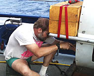 Yogi making adjustments to the DSL-120 sonar. The yellow blocks next to his head are pieces of syntactic foam flotation that help make the sonar fish neutrally buoyant at depth. 